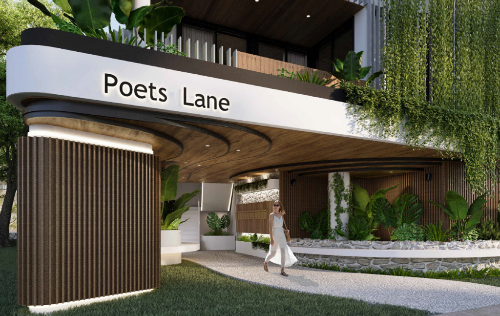 The eastward view of Poets Lane’s entry, showcasing the contemporary architecture and surrounding landscaping that offers a serene approach to the building.